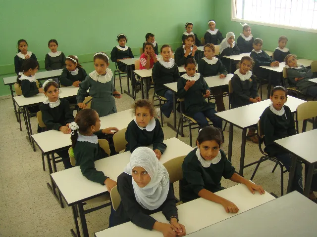 Palestinian schoolgirls seated at desks in a classroom in the Gaza Strip
